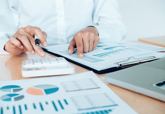 Finances Saveing Economy concept. Female accountant or banker use calculator.