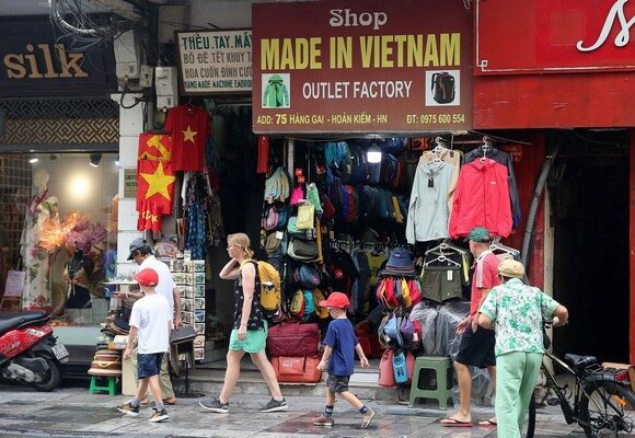 epa12211759 Tourists walk past a 'Made in Vietnam' store at a street in Hanoi, Vietnam, 03 July 2025. The United States has reached a trade agreement with Vietnam, according to a social media post made by US President Donald Trump. Trump said the US will impose a 20 percent tariff on Vietnamese exports to the country and a 40 percent tariff on trans-shipments from third countries routed through Vietnam, while Vietnam will accept US goods with zero tariffs.  EPA/LUONG THAI LINH