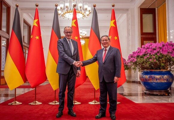 epa12775440 Chancellor of Germany Friedrich Merz (L) and Premier of China Li Qiang shake hands at the Great Hall of the People in Beijing, China, 25 February 2026. Merz is visiting China for the first time as Chancellor.  EPA/Michael Kappeler / POOL alle Agenturen